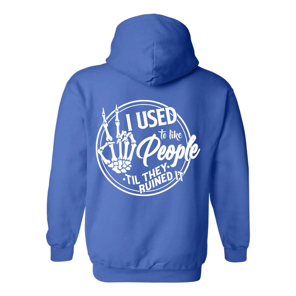 
                  
                    A maroon hoodie with a printed phrase 'I Used to Like People' on the back, featuring a cheeky skeleton hand design.
                  
                